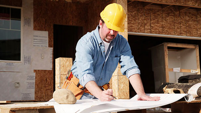 Male foreman reviewing plans on a job site
